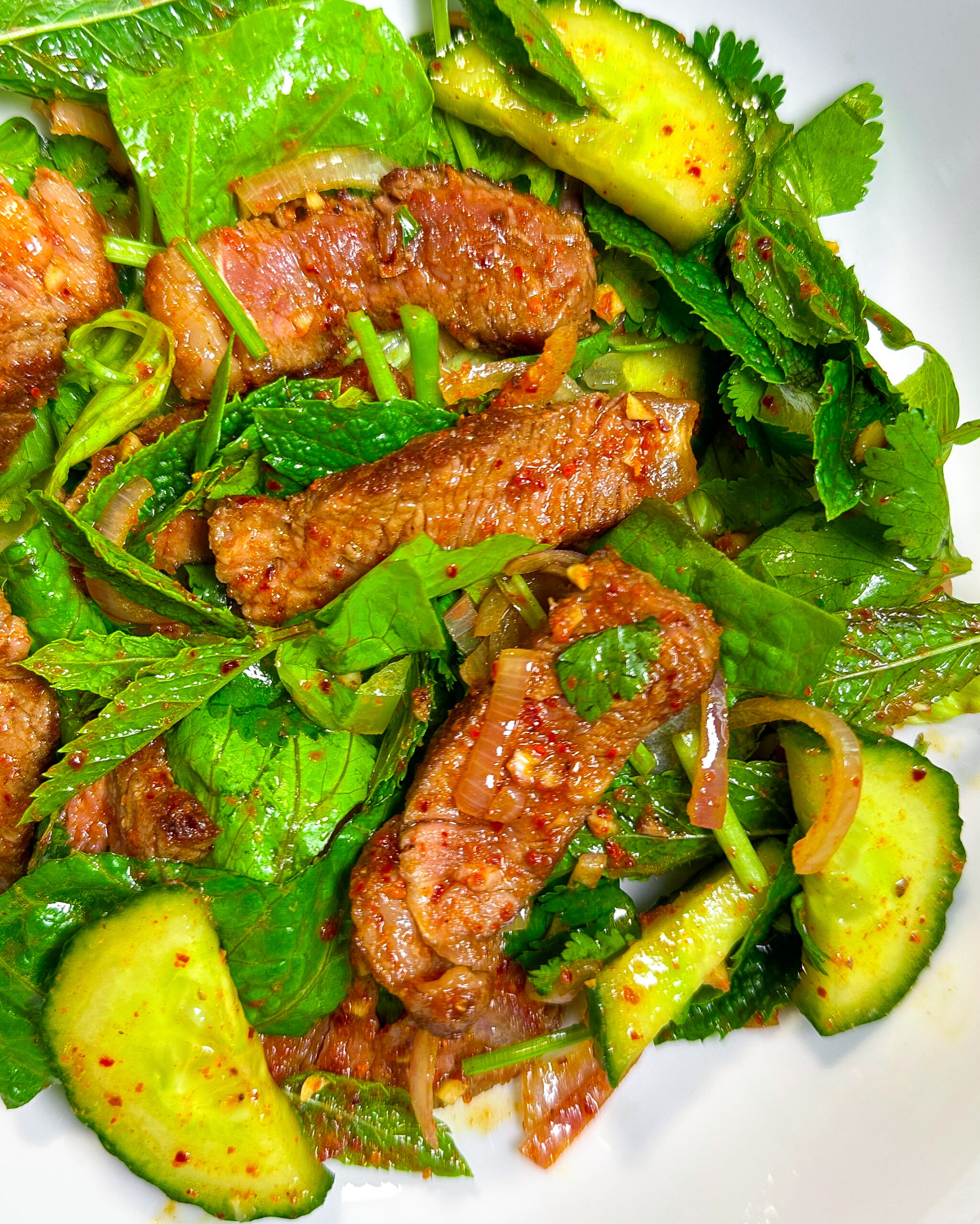 thai sirloin steak salad with cucumber, lime, mint, cilantro, lettuce, fish sauce, chilli, sugar